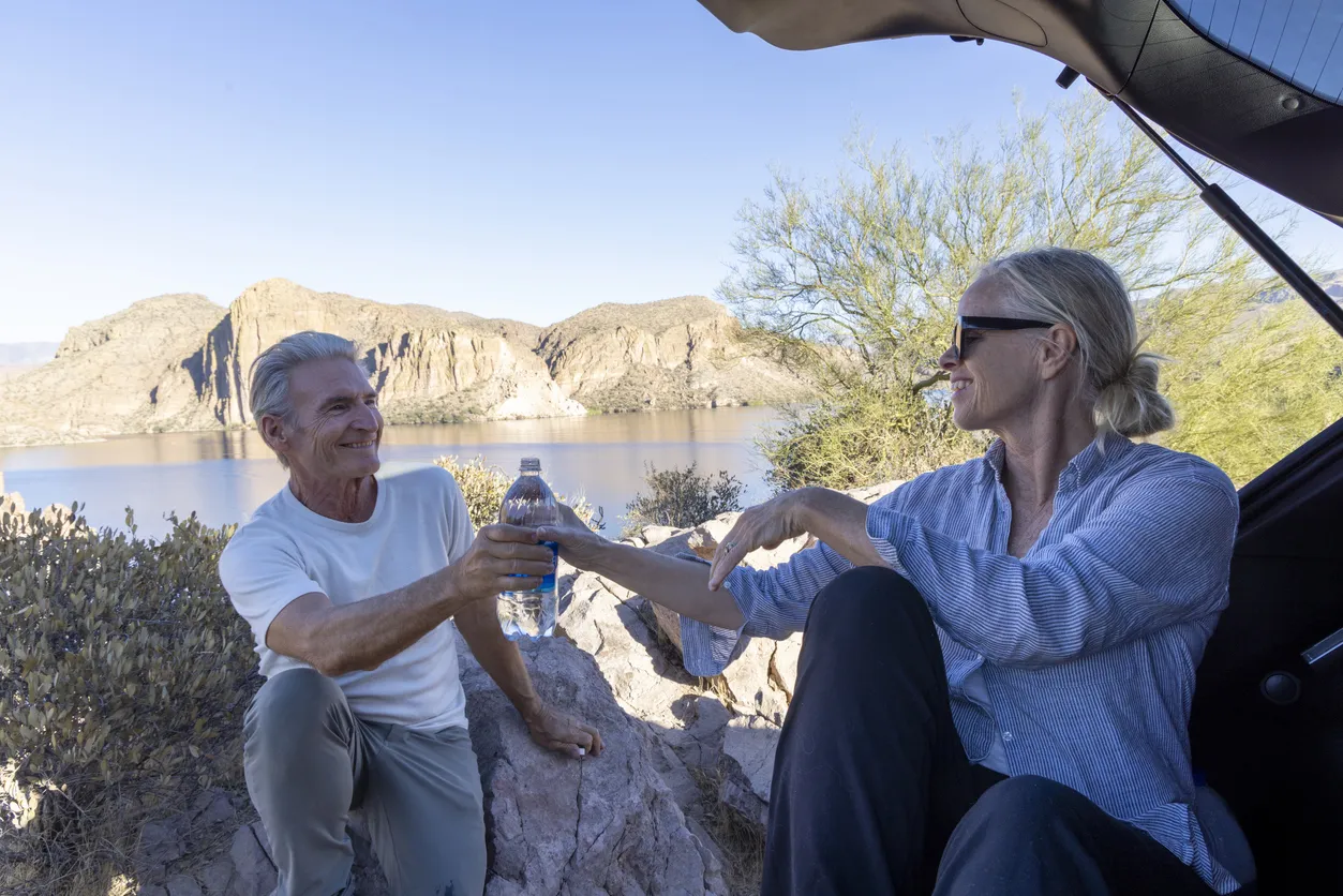 Senior Couple Talking Whether Wickenburg Is An Ideal Retirement Living With The Background Of Lake