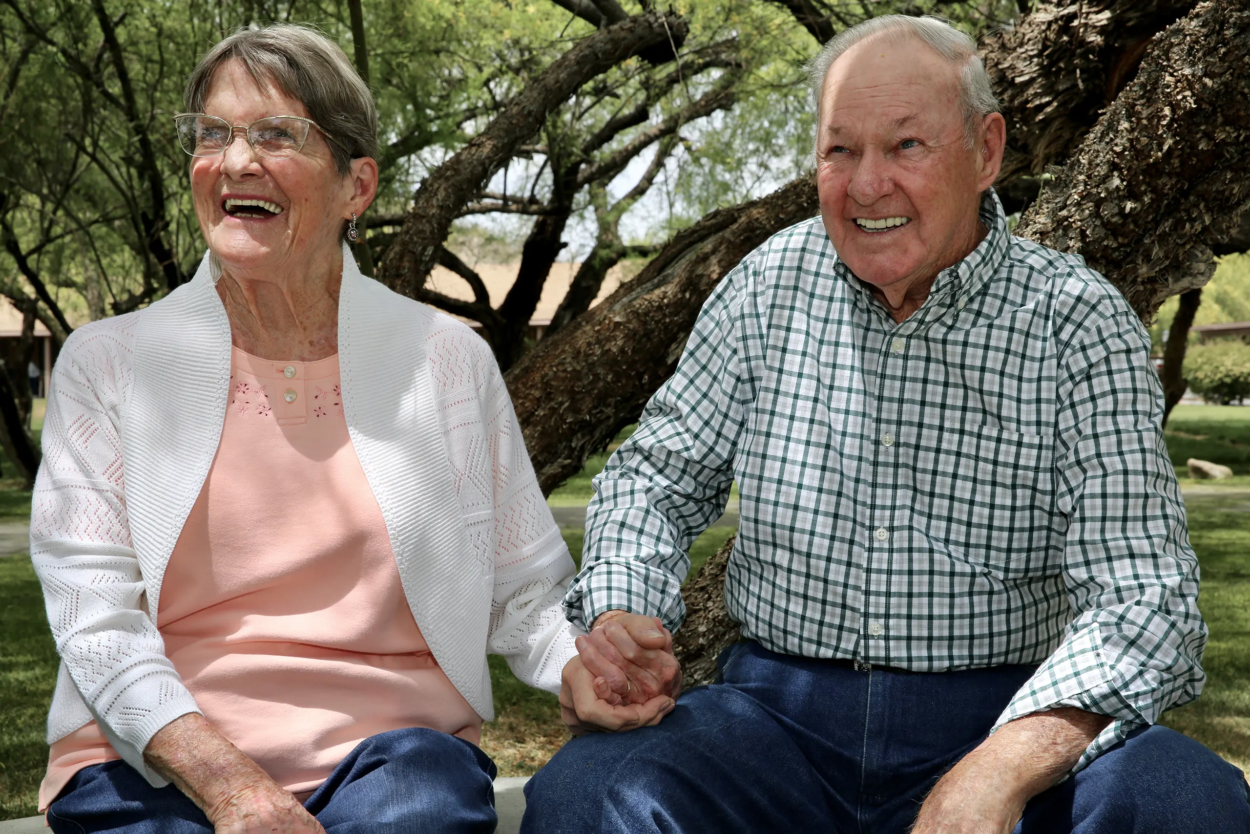 Happy senior couple outdoors at a memory care in Arizona community in Wickenburg
