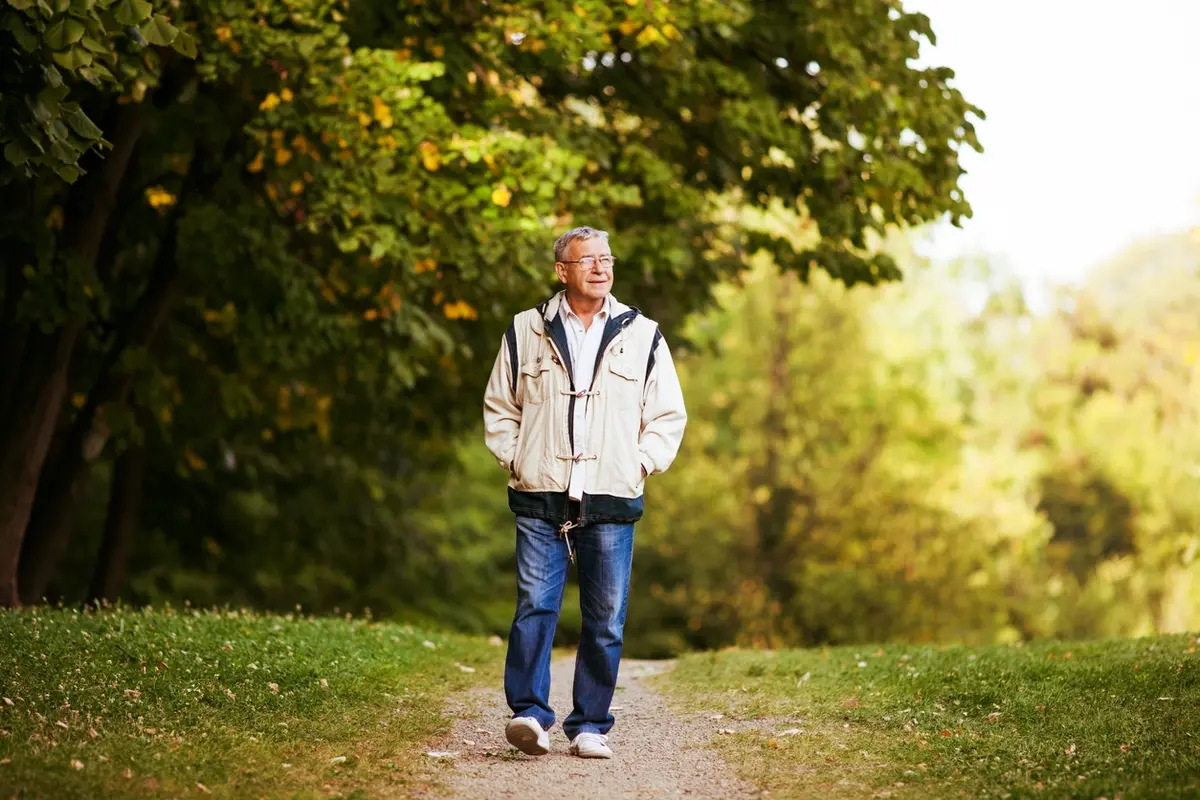 Senior man walking alone outdoors, illustrating when a parent with dementia keeps wandering